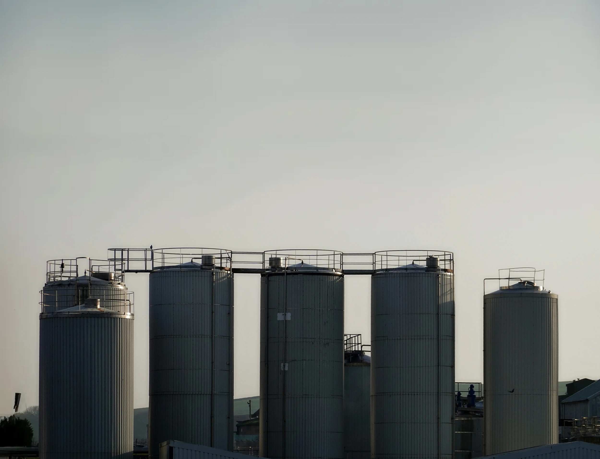 Industrial silos against an overcast sky